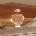 Paco Rabanne Olympéa Eau de Parfum 50ml perfume bottle on a desert background