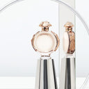 Paco Rabanne Olympéa Eau de Parfum 50ml perfume bottle with a reflective surface background
