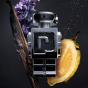 robot shaped Paco Rabanne Phantom Eau de Toilette 50ml perfume bottle with floral and fruit elements on a dark background