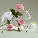 Pink roses, a moon, limes, and decorative elements on a light background