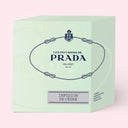 light green Prada Infusion De Cèdre Candle 165g packaging with brand logo on a light pink background