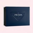 Blue Prada gift box on a light pink background