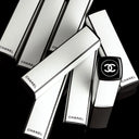 Chanel ROUGE ALLURE VELVET NUIT BLANCHE lipsticks and packaging on a black background