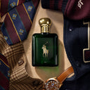 Ralph Lauren Polo Oud Eau de Parfum 125ml fragrance bottle with a watch, tie, and coat in the background