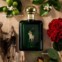 Green Ralph Lauren Polo Oud Eau de Parfum 125ml perfume bottle with gold cap on a textured surface with flowers and leaves