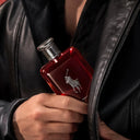 Ralph Lauren Polo Red Parfum 125ml perfume bottle held by a person wearing a black leather jacket