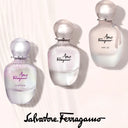 Three Salvatore Ferragamo Amo range perfume bottles on a light background