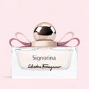 Salvatore Ferragamo Signorina Eau de Parfum 30ml perfume bottle with a pink ribbon on a light pink background