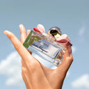 Hand holding a Salvatore Ferragamo Signorina Eau de Parfum 30ml perfume bottle against a blue sky background