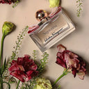 Salvatore Ferragamo Signorina Eau de Parfum 30ml perfume bottle surrounded by flowers on a light background