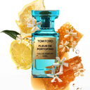 BEAUTE KNOWS Aqua blue Tom Ford Fleur De Portofino Eau De Parfum 50ml perfume bottle with lemons, oranges and flowers on a white background