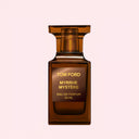 BEAUTE KNOWS Brown bottle of Tom Ford Myrrhe Mystère Eau De Parfum 50ml perfume bottle on a light neutral pink background