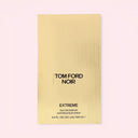 BEAUTE KNOWS Gold Tom Ford Noir Extreme Eau De Parfum 100ml perfume packaging on a light pink background