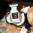 Tom Ford Soleil Blanc Eau de Parfum 50ml perfume bottle on a coconut with a blurred background