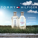 Two Tommy Hilfiger perfume bottles on grass with a blue sky background