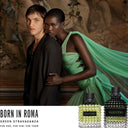 Anwar Hadid and a female model standing together with two Valentino Donna Born In Roma Green Stravaganza Eau de Parfum perfume bottles displayed below
