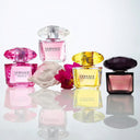 Versace perfume bottles on a reflective surface with a white background