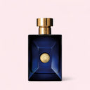 Blue Versace Dylan Blue Pour Homme Eau de Toilette 50ml perfume bottle with gold cap and emblem on a light pink background