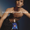 Versace Dylan Blue Pour Homme Eau de Toilette 50ml perfume with a model in the background