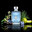 Blue Versace Pour Homme Eau de Toilette 50ml perfume bottle with silver cap surrounded by flowers and a lime on a reflective surface.
