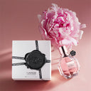 Viktor & Rolf Flowerbomb Eau de Parfum 50ml perfume bottle and packaging with a pink flower on a pink background