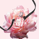 Viktor & Rolf Flowerbomb Eau de Parfum 50ml perfume bottle on a pink rose with visible branding.