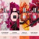 Four Viktor & Rolf Flowerbomb perfume bottles with floral designs and color names.