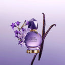 Viktor & Rolf Good Fortune Eau de Parfum 50ml perfume bottle with flowers and vanilla beans on a purple background