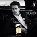 campaign image of a man in the backseat of a car with Yves Saint Laurent L'Homme perfume bottle
