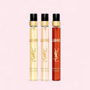 Three YSL Libre perfume travel sized pen spray bottles in different colors on a light pink background