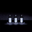 BEAUTE KNOWS Maison Margiela Replica Fantasies perfume bottles featuring Soul of The Forest in a dark studio setting.