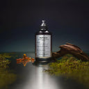 BEAUTE KNOWS Maison Margiela Replica Soul of The Forest perfume bottle on a mossy surface with driftwood