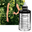 BEAUTE KNOWS Maison Margiela Replica Soul of The Forest perfume bottle against a lush green forest background