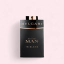 Bulgari Man in Black Miniature perfume bottle on a light pink background